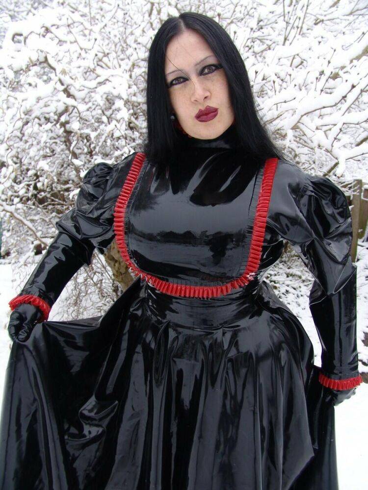 Goth woman Lady Angelina models a black latex dress on snow-covered ground - #3