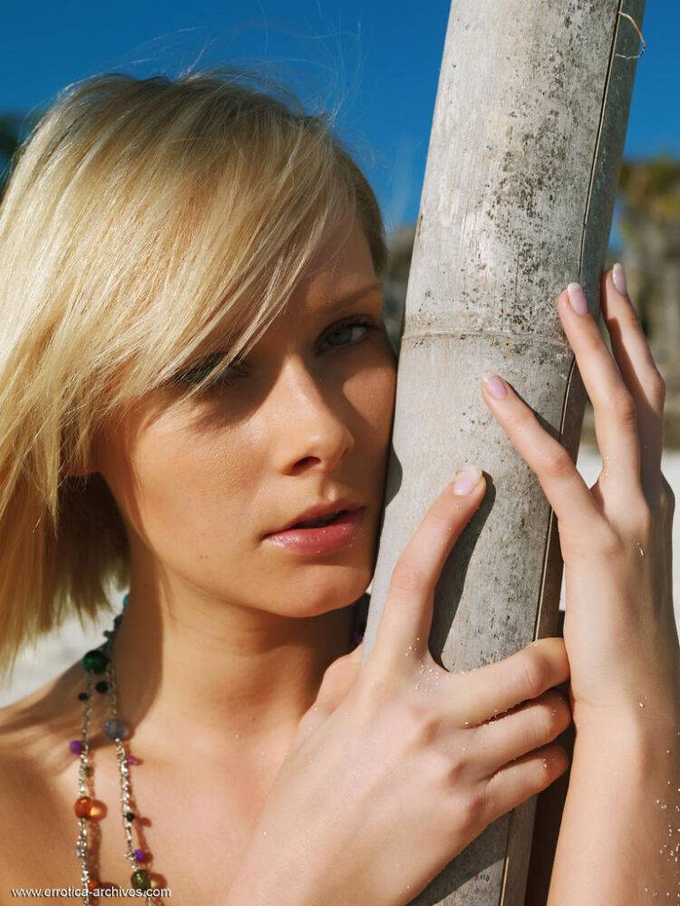 Pretty blonde Deni models completely naked on a sandy beach - #9