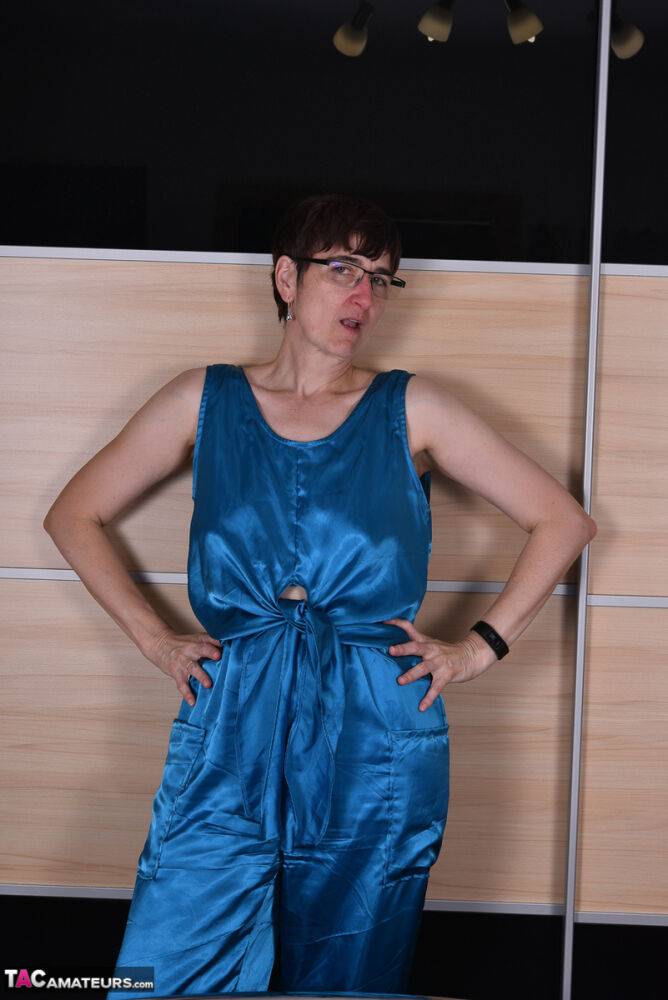 Amateur woman models satin evening wear on a bed with her glasses on - #14