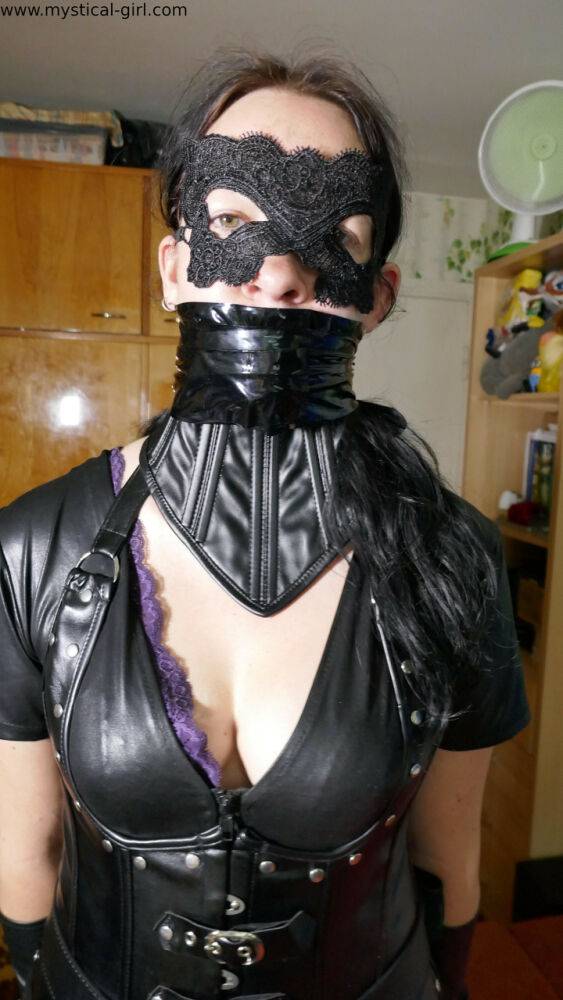 Brunette female models leather clothing while wearing a mask - #4