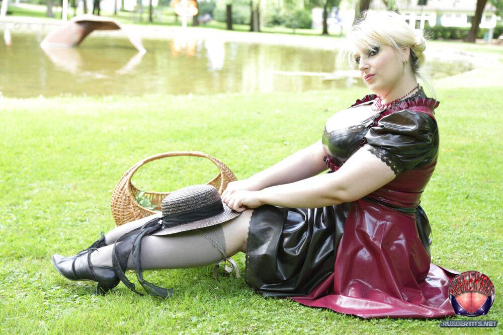 Overweight blonde Darkwing Zero models on a lawn in a rubber dress - #11