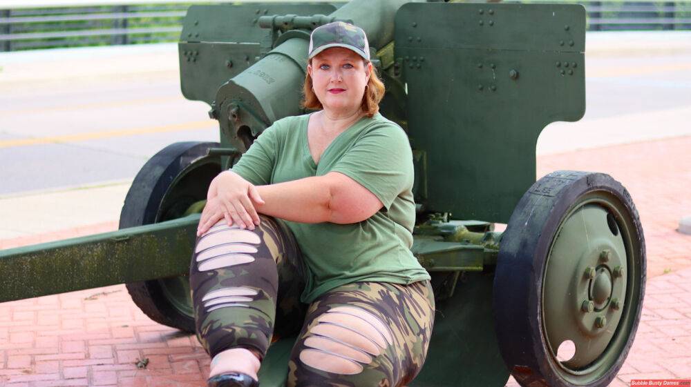 Obese amateur Goddess Pear models for a SFW shoot on an artillery gun in camo - #1