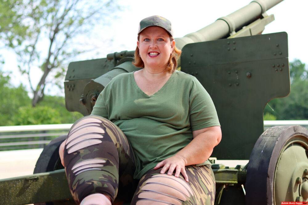 Obese amateur Goddess Pear models for a SFW shoot on an artillery gun in camo - #12