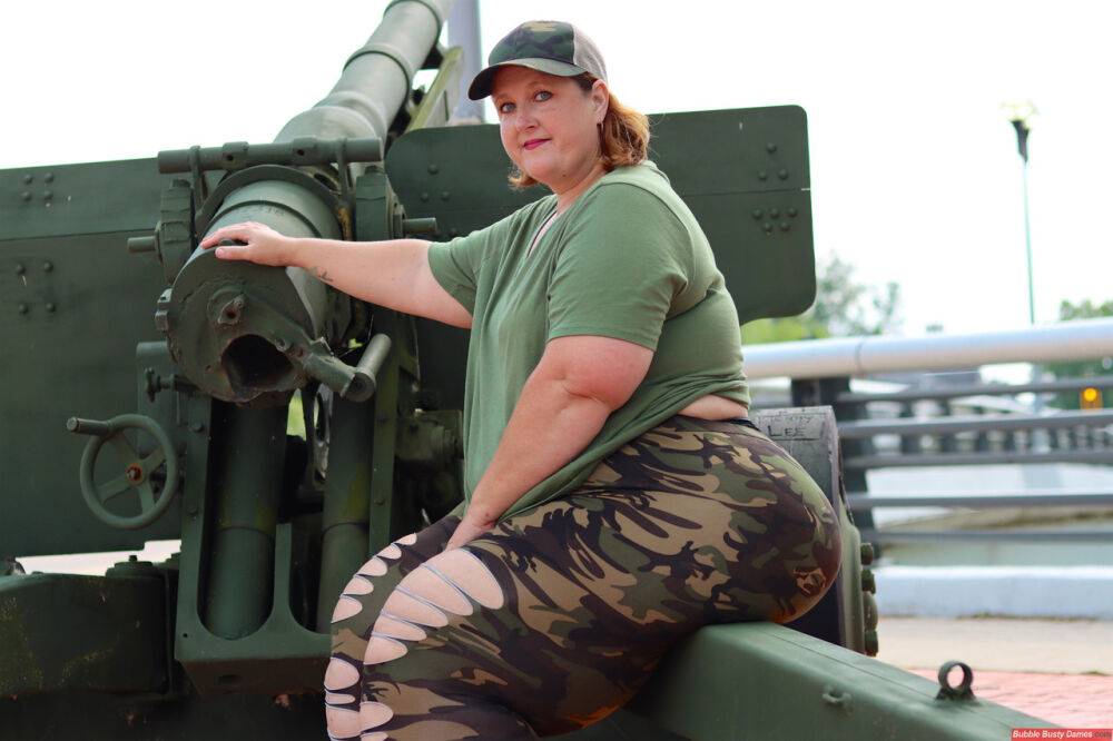 Obese amateur Goddess Pear models for a SFW shoot on an artillery gun in camo - #10