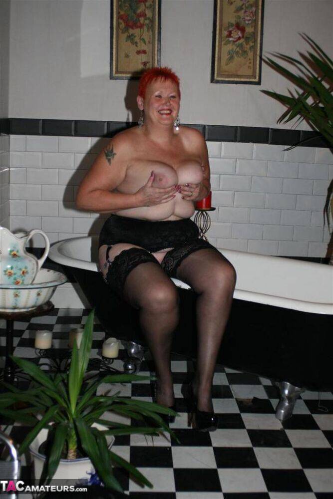 Older redhead Valgasmic Exposed models on the side of a claw tub in hosiery - #5