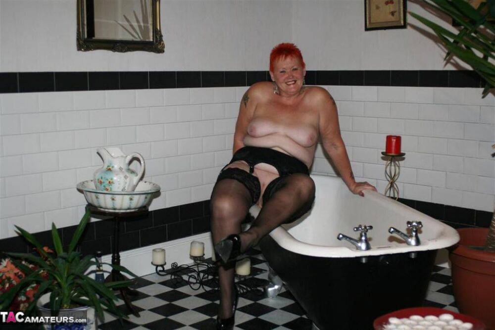 Older redhead Valgasmic Exposed models on the side of a claw tub in hosiery - #4