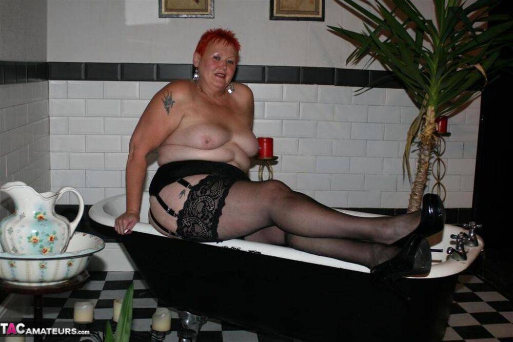 Older redhead Valgasmic Exposed models on the side of a claw tub in hosiery - #10