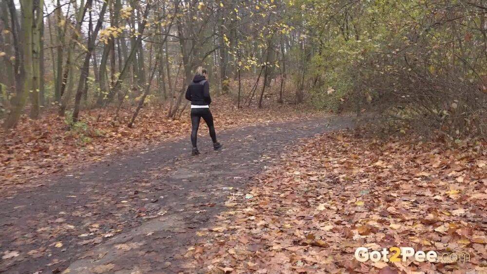 White girl Naomi Bennet takes a pee on a path while walking through a forest - #9