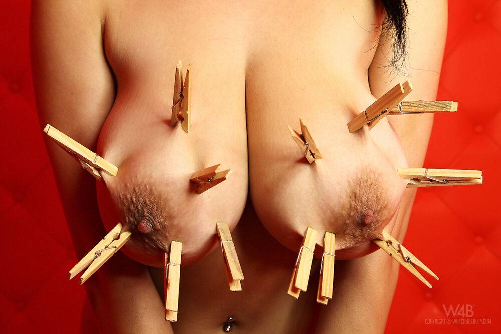 Naked female Shione affixes clothes pegs to her hooters and tongue | Photo: 2895735