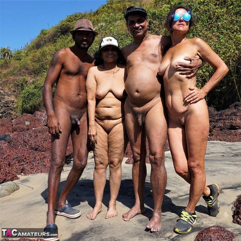 Mature amateur Diana Ananta is joined on the beach by her nudist friends - #7