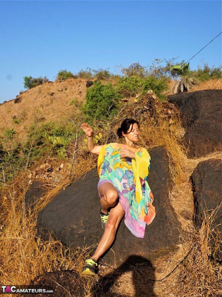 Older lady Diana Ananta exposes herself during a hike to a shrine atop a cliff - #9