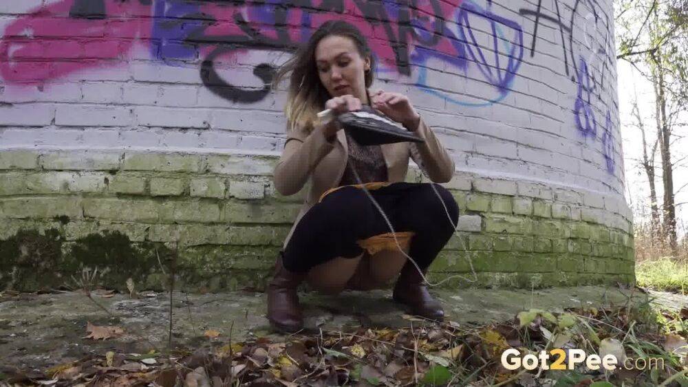 White girl Diana takes a badly needed piss behind a bricked structure - #13