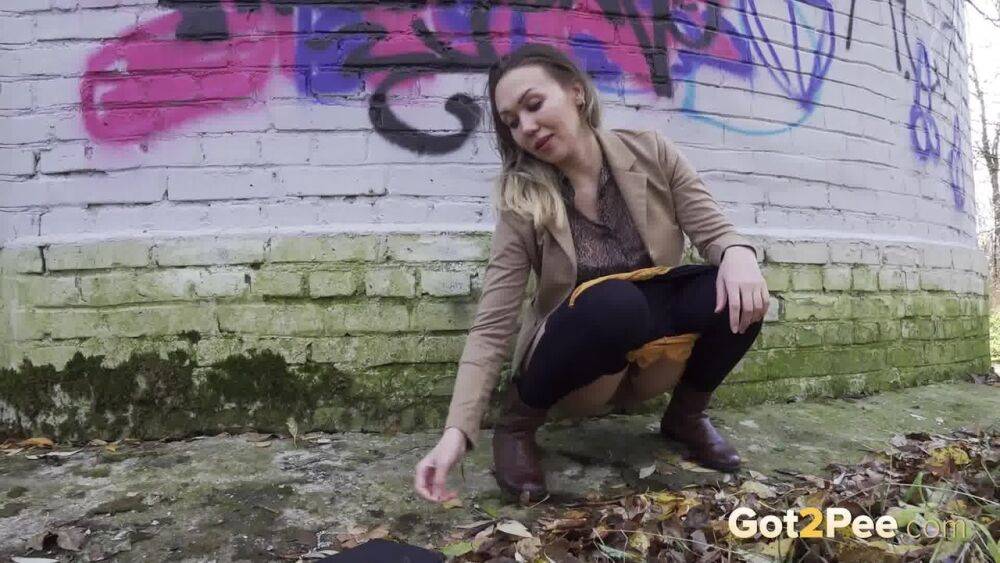 White girl Diana takes a badly needed piss behind a bricked structure - #12