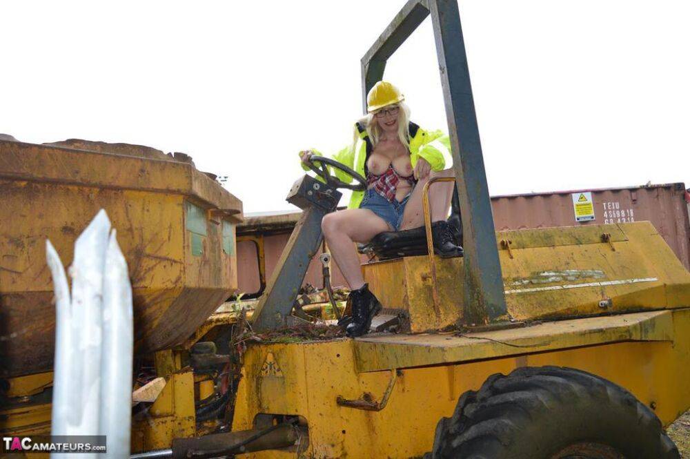 Mature amateur Barby Slut exposes herself on heavy equipment at a job site - #2