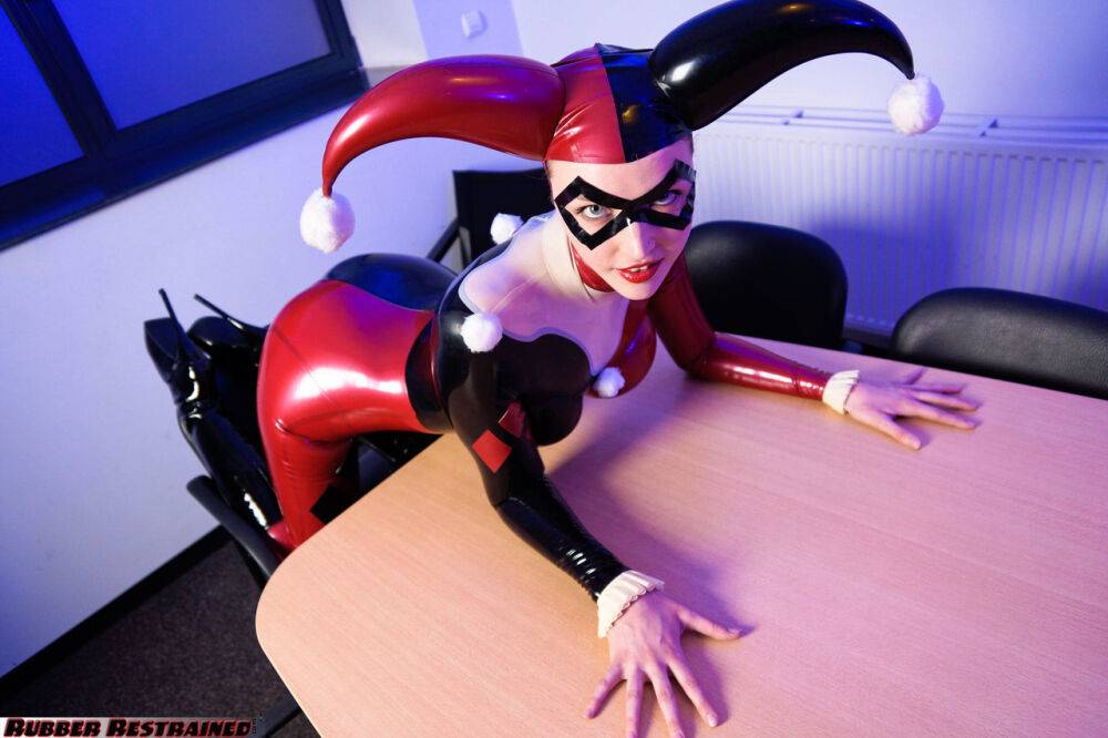 Solo model Harley Quinn poses for a non nude shoot in a costume made of latex - #1