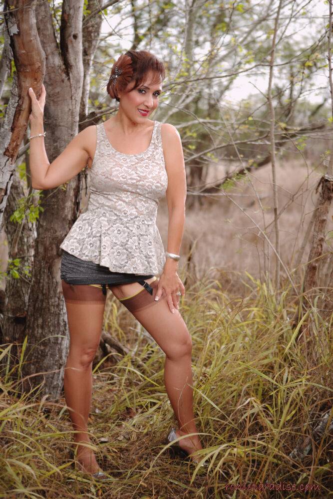 Mature pinup model Roni Ford kicks off pumps wearing retro lingerie in woods - #1