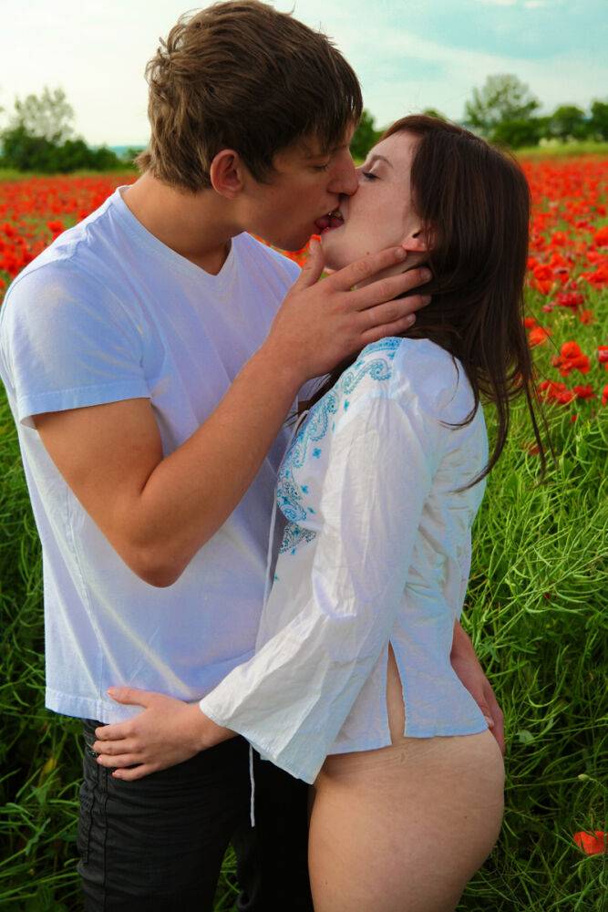 Young couple has sexual intercourse in a field of blooming poppies | Photo: 3082012