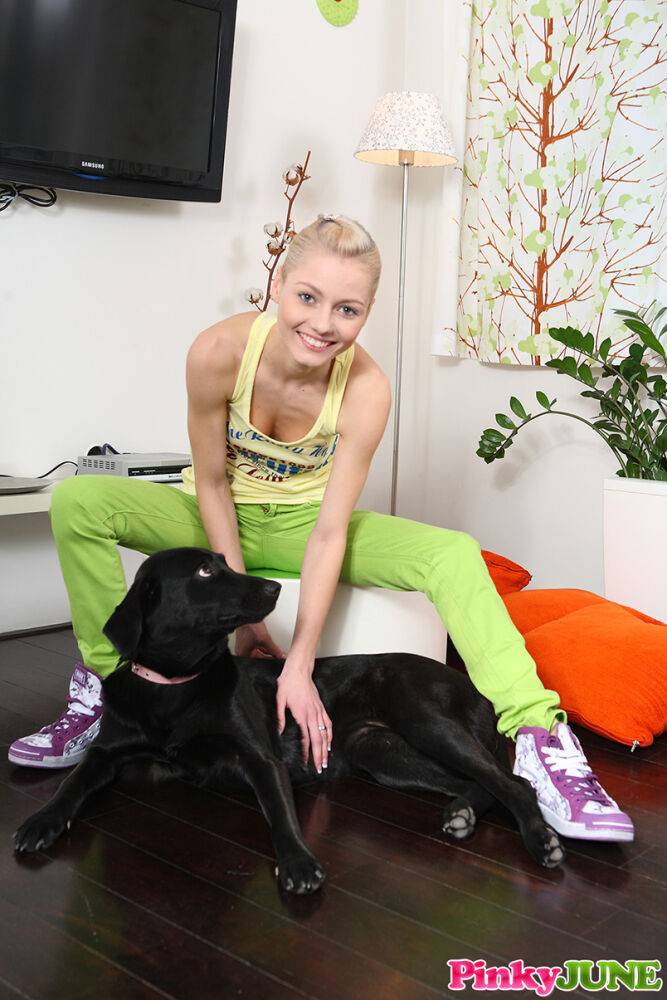 Cute blonde teen Pinky June plays with her dog before taking off her tank top - #11