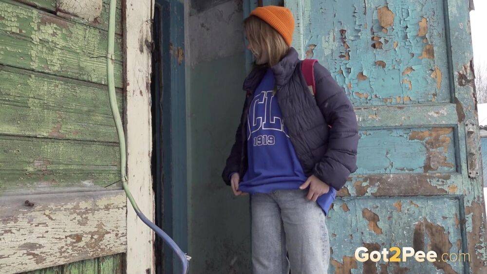 Cute girl pulls down jeans for an urgent piss on the steps of an old building - #7