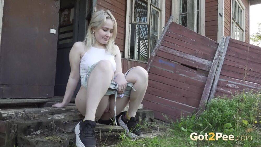 Blonde girl Nastya takes a piss on the steps of an abandoned cabin - #15