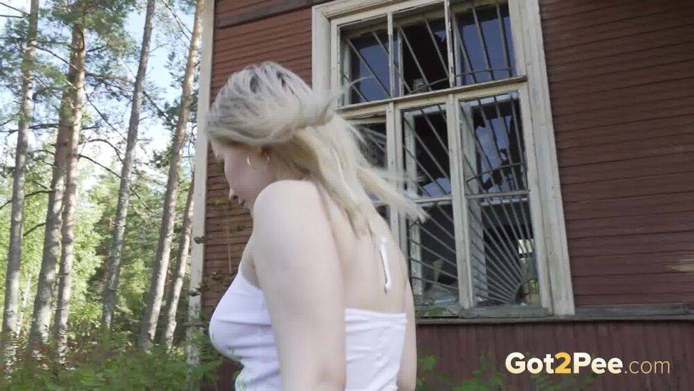 Blonde girl Nastya takes a piss on the steps of an abandoned cabin - #2