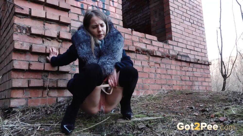 Distressed girl Nastya pulls down her tights to pee by an abandoned building - #14