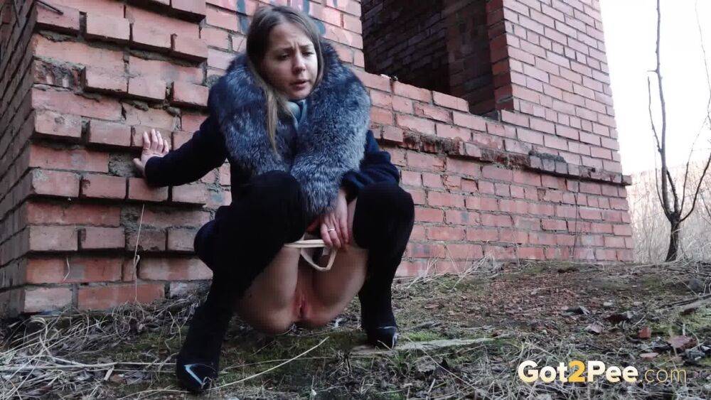 Distressed girl Nastya pulls down her tights to pee by an abandoned building - #15