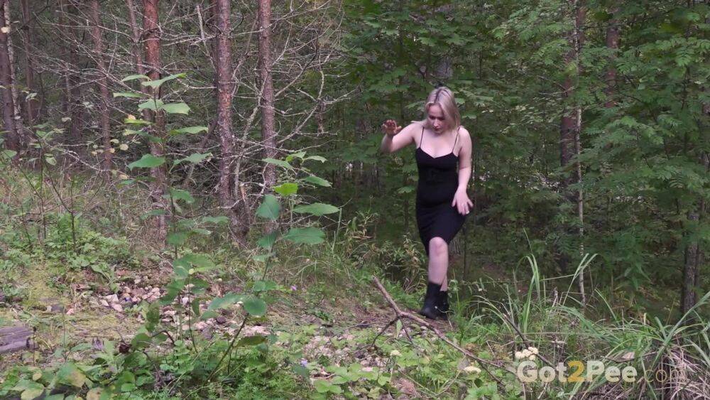 Blonde girl hikes up a black dress to piss in the woods while wearing Docs - #2