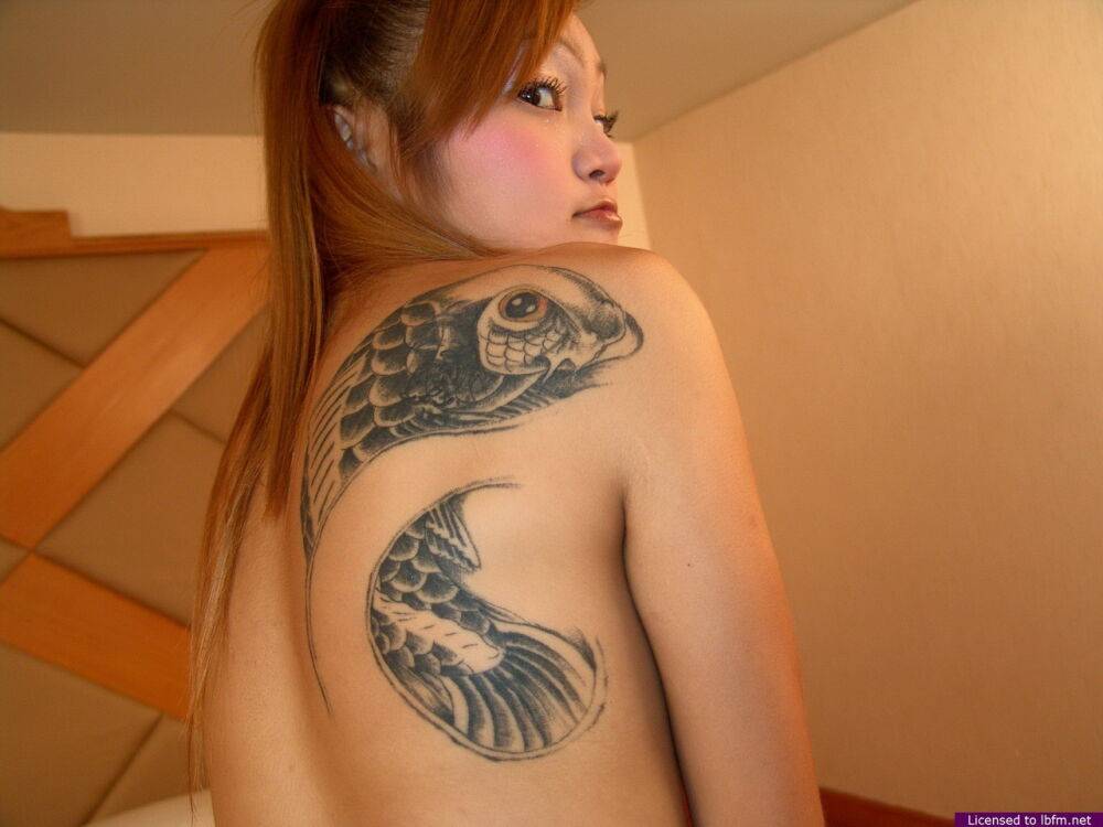 Wild Asian teen sheds her shorts and shirt to show big tattoo and tiny tits - #6