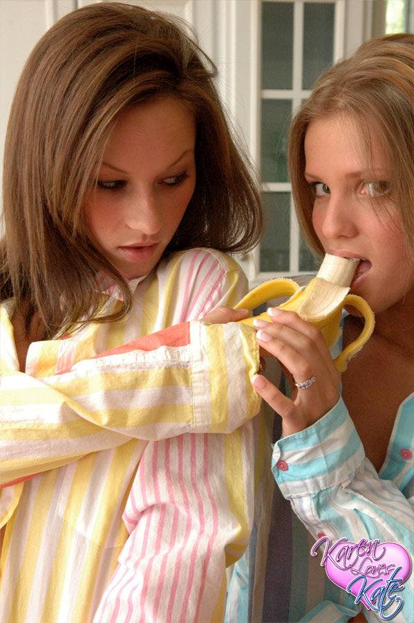 Teen lesbians Karen and Kate fool around with a banana in their pajamas - #12