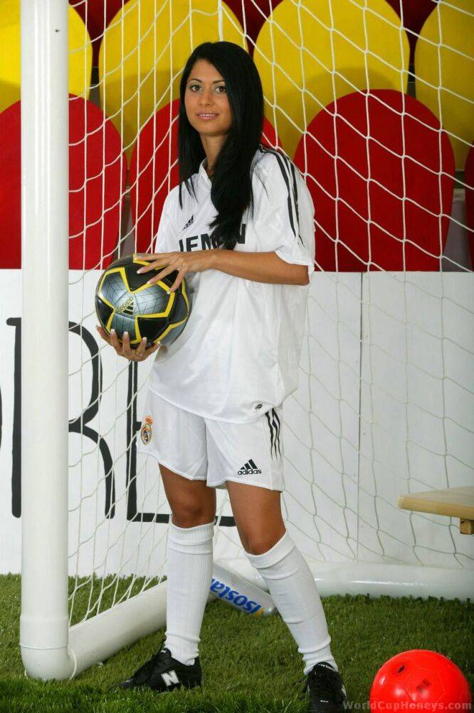 Soccer tender with long black hair strips to knee socks and cleats in goal - #5