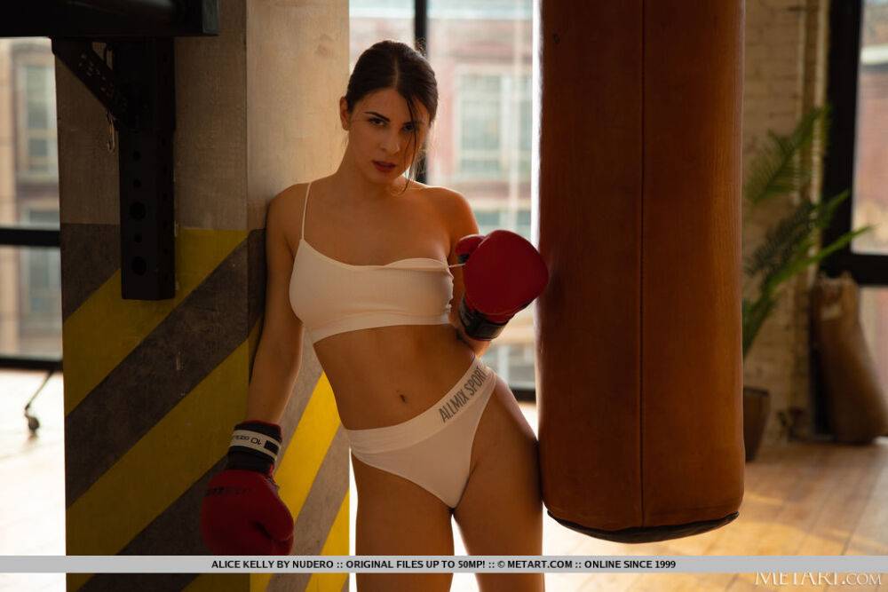 Athletic teen Alice Kelly strips to OTK socks during a punching bag workout - #3