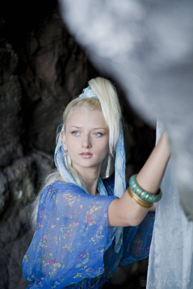 Young looking blonde Nika N finger fucks in a cave before blowing a kiss - #12