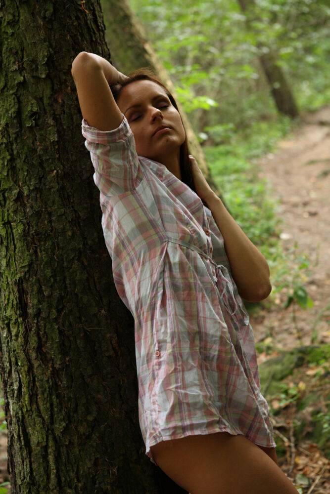 Young girl poses in the nude for the first time while in a forest - #11