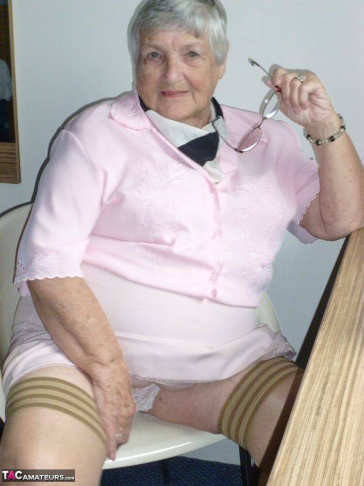 Obese old woman Grandma Libby lays her floppy tits on a desk while undressing - #2