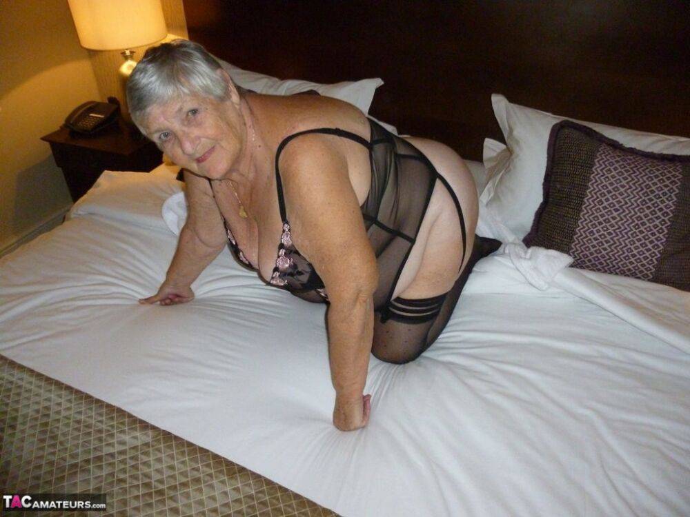 Old woman Grandma Libby displays her fat figure on a bed in sheer stockings - #16