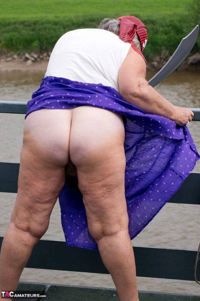 Fat British granny exposes herself on a bridge while sporting pirate attire - #13