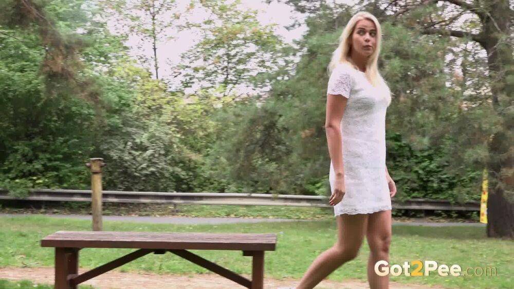 Beautiful blonde Nikki Dream in white lace dress pauses to pee in the park - #10