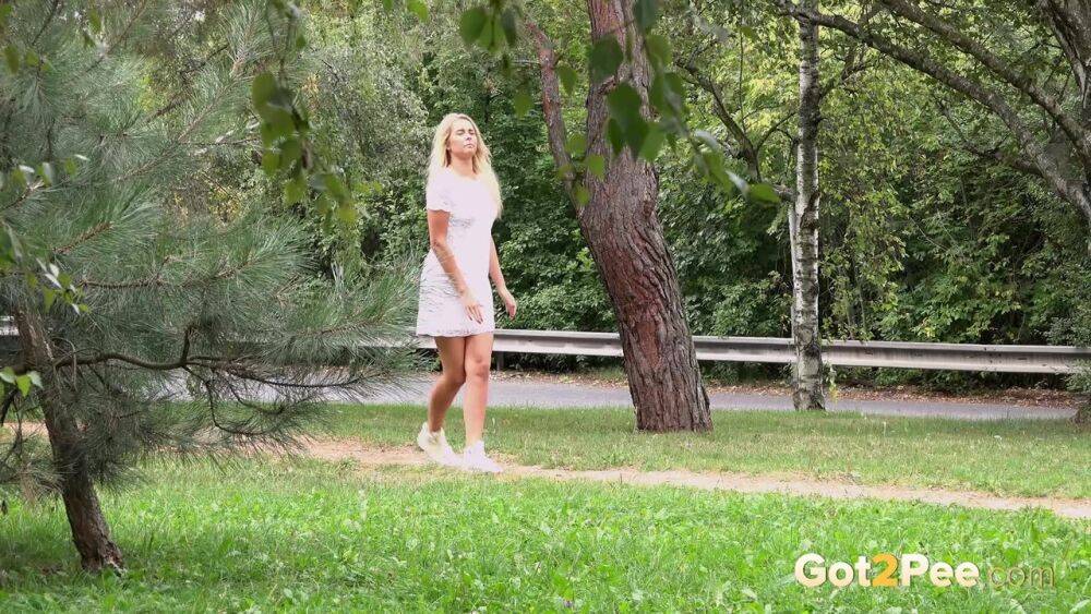 Beautiful blonde Nikki Dream in white lace dress pauses to pee in the park - #15