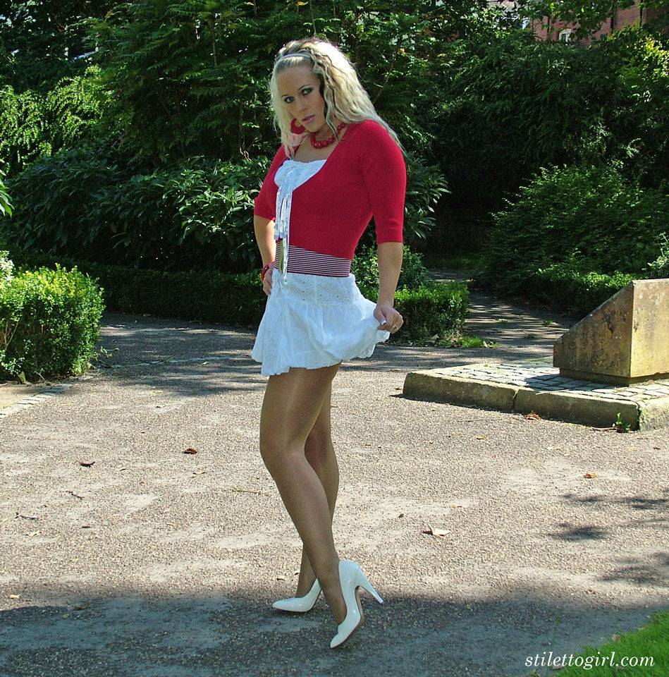 Hot blonde in short skirt flaunts her long legs in white heels at the park - #1