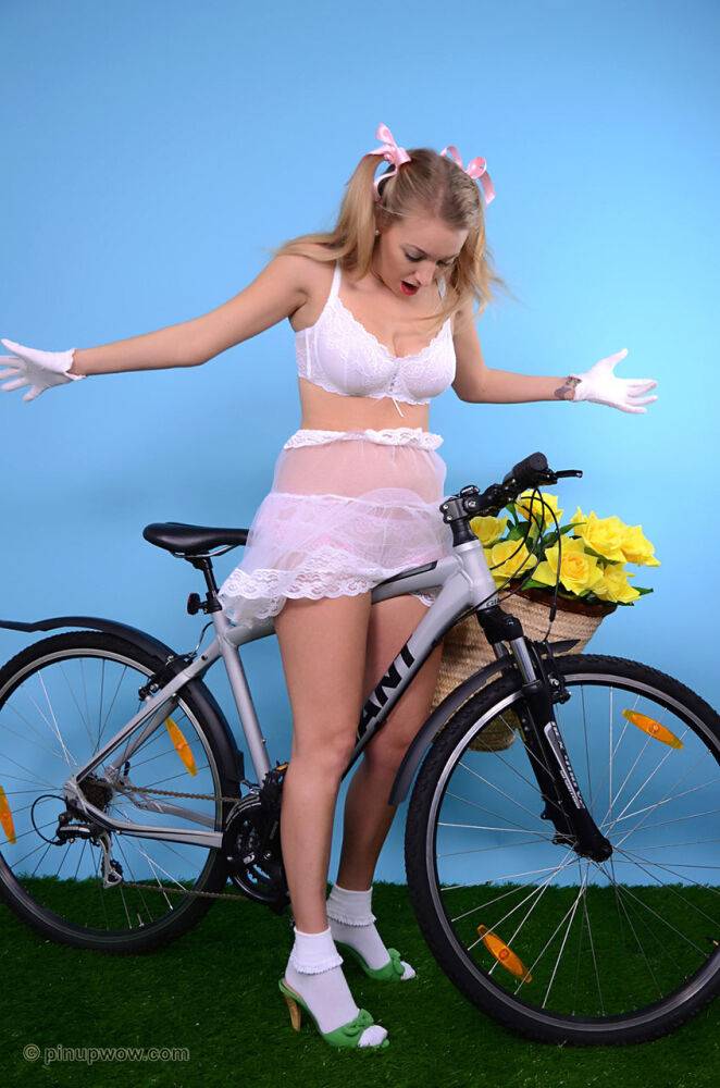 Cute blond bares her firm tits on a bicycle in white gloves and frilly panties - #15