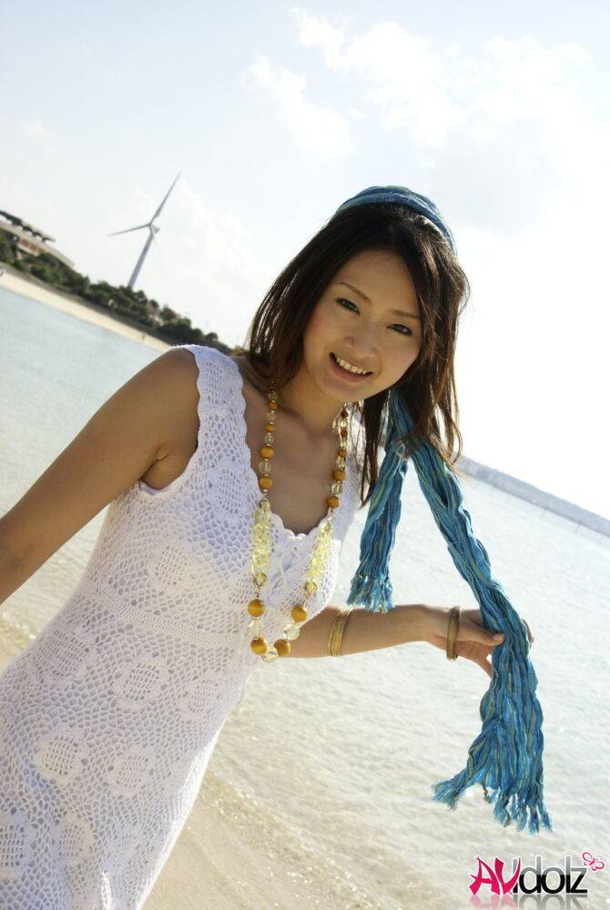 Asian girl wander into the ocean to her knees in a white dress - #2