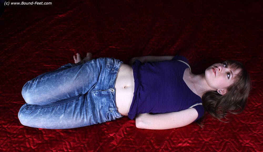 Barefoot white girl Agnes is hogtied in a shirt and blue jeans - #6