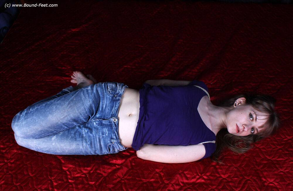 Barefoot white girl Agnes is hogtied in a shirt and blue jeans - #3