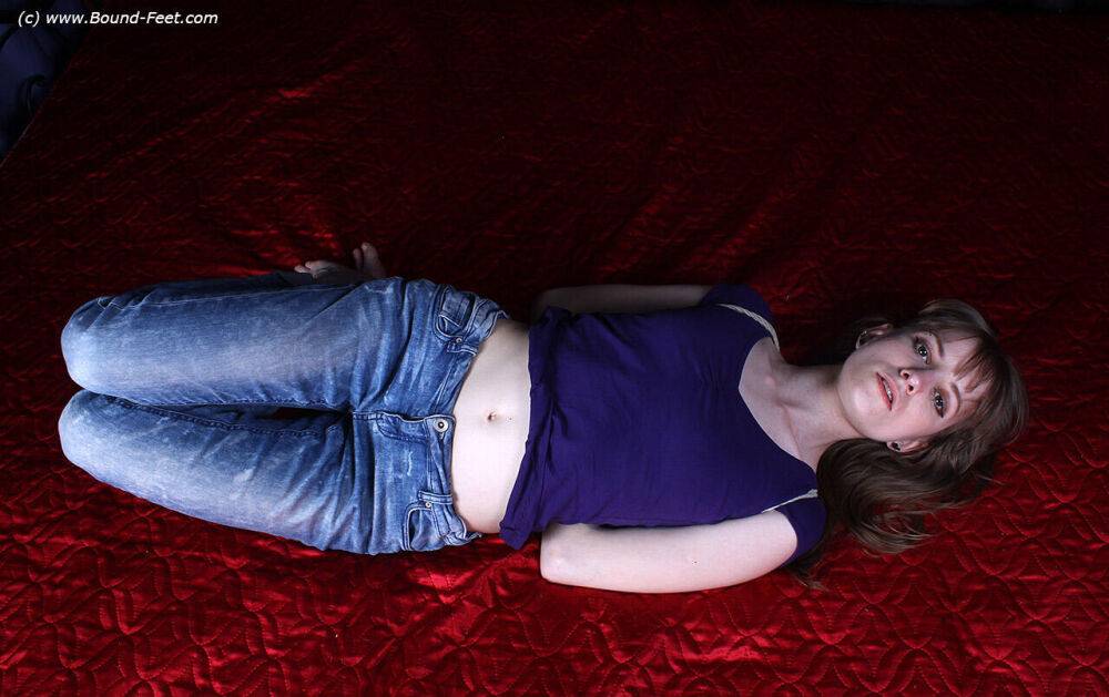 Barefoot white girl Agnes is hogtied in a shirt and blue jeans - #1