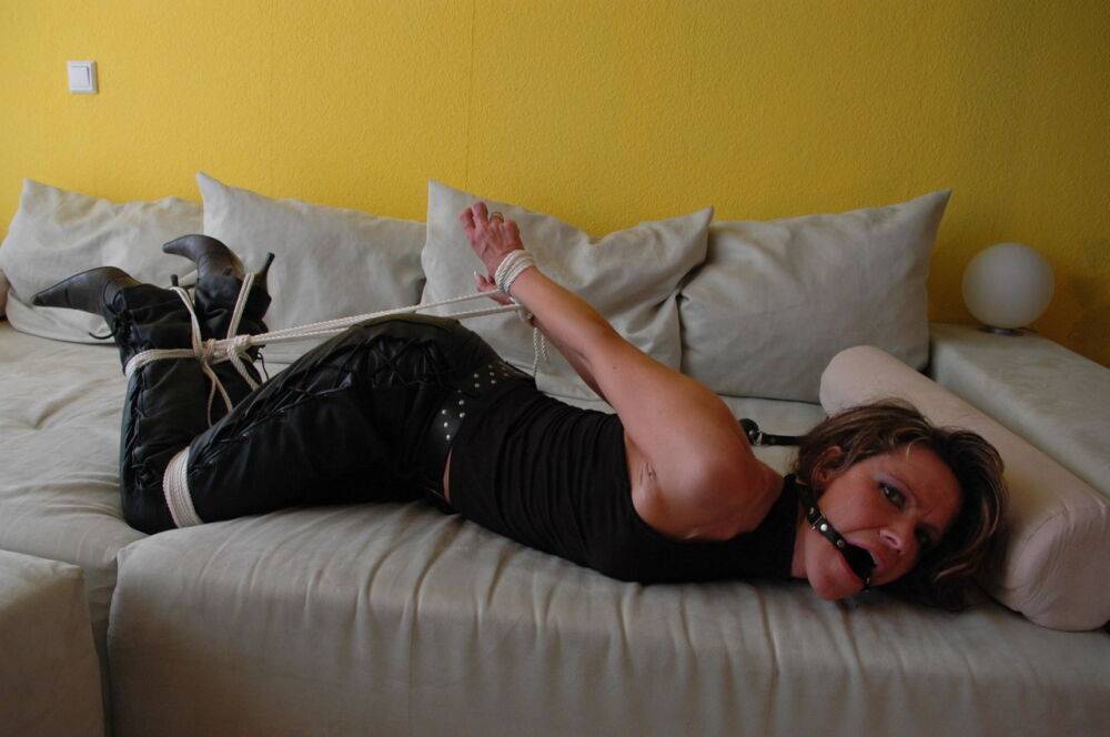 White chick struggles against a ball gag and rope bindings in leather pants - #7