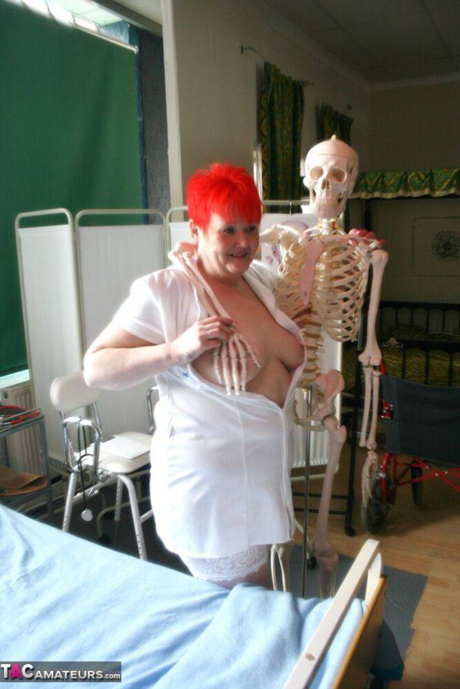 Slutty mature nurse in white stockings gets toyed up by a skeleton - #16