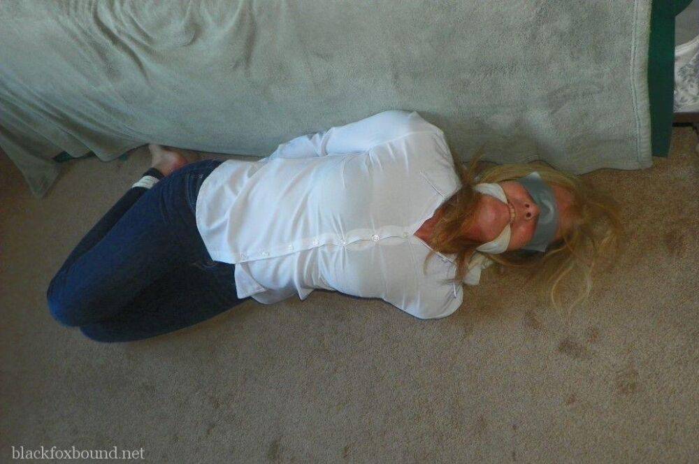 Blonde woman is cleave gagged and hogtied in a white blouse and blue jeans - #14