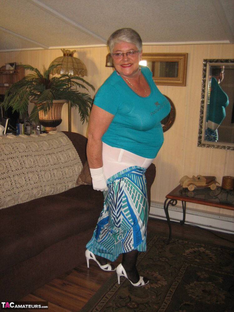 Fat Oma Girdle Goddess wears white gloves while disrobing to a bra and girdle - #15