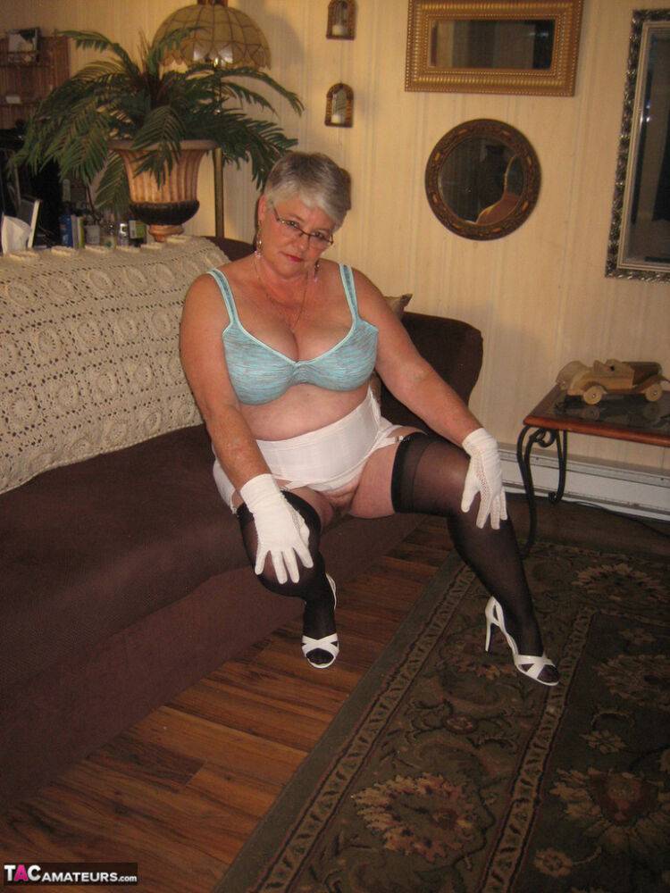 Fat Oma Girdle Goddess wears white gloves while disrobing to a bra and girdle - #4